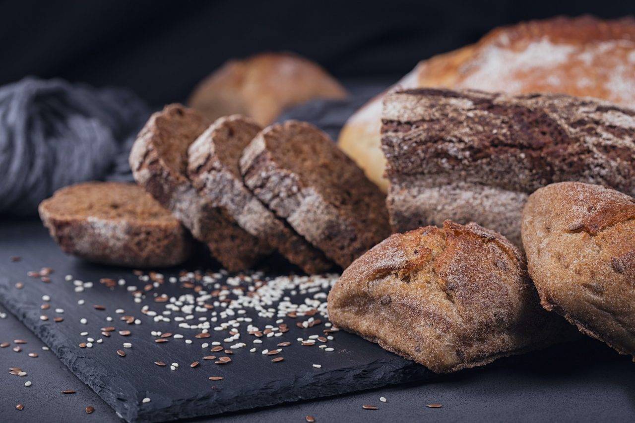 assortment-of-baked-bread-on-dark-background-